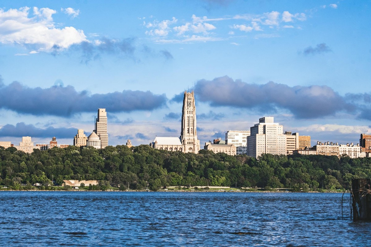View of Riverside Church and New York skyline across the Hudson River on a sunny day.