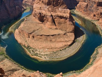 Breathtaking aerial view of Horseshoe Bend in Glen Canyon with Colorado River flowing around it.