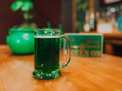 Close-up of a green beer mug on a wooden table, perfect for St. Patrick's Day celebration.