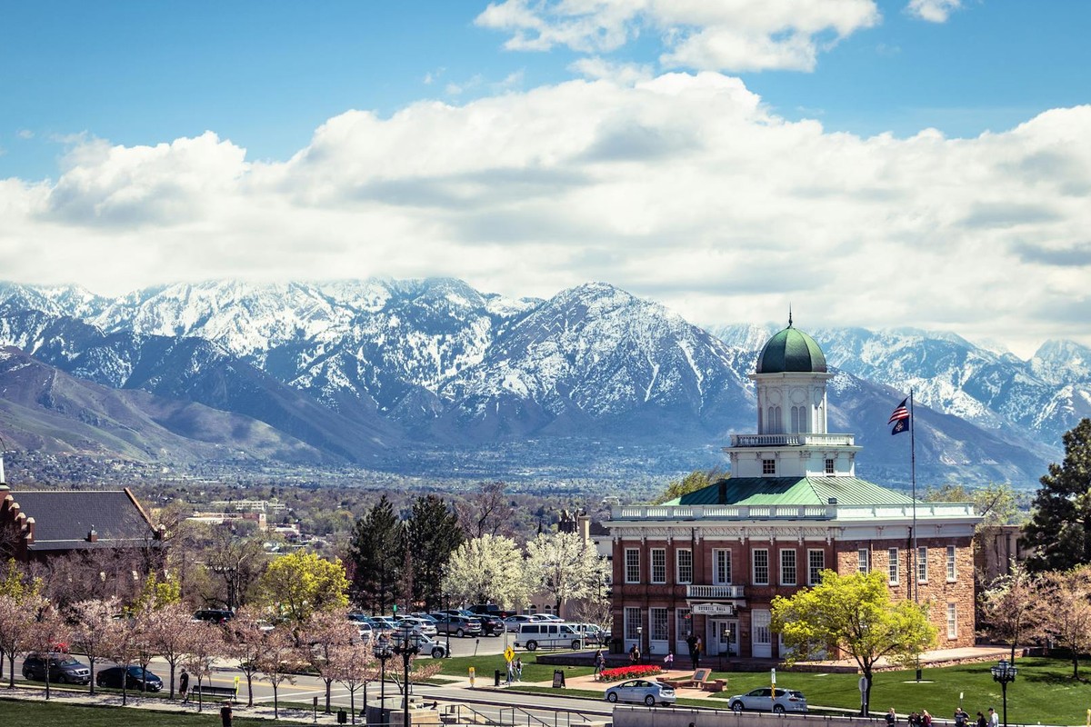 A picturesque view of Salt Lake City's historic buildings against the snow-capped mountains.