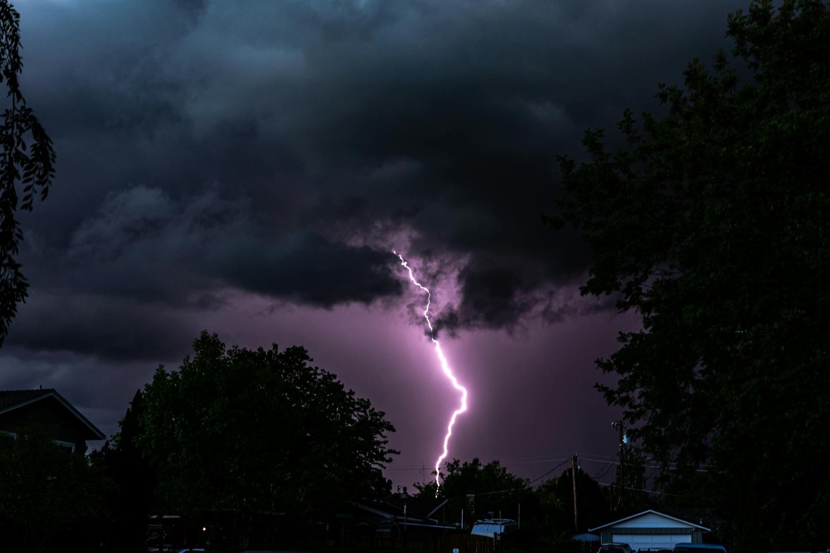 Dramatic lightning illuminates a stormy night sky over suburban Chico, CA.