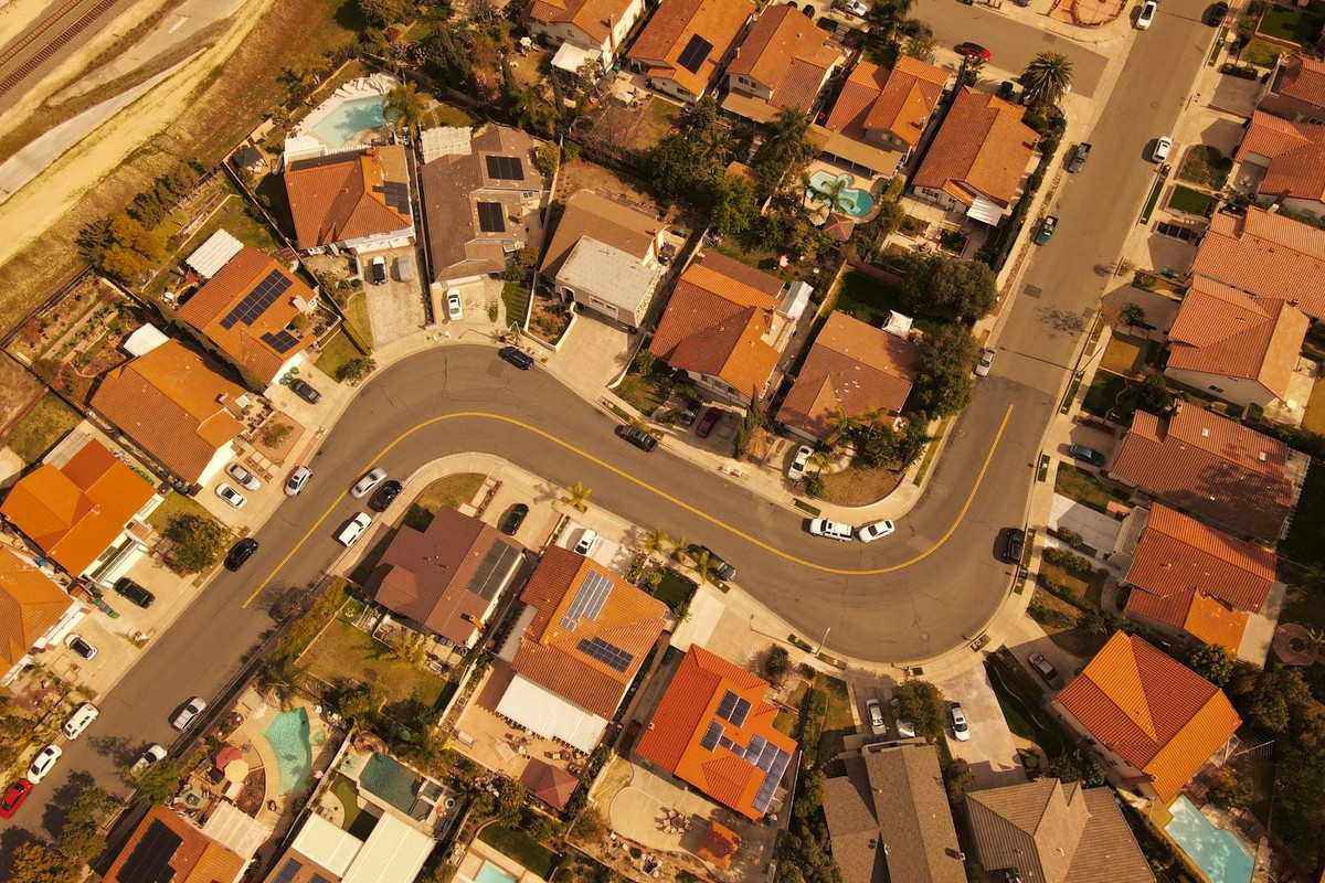 Aerial perspective of Mission Viejo residential area showcasing curved streets and solar-paneled rooftops.