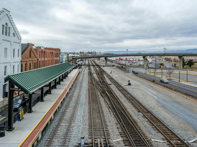 Elevated view of Roanoke train station with railway tracks, showcasing urban transportation infrastructure.