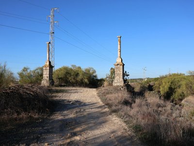Two ancient columns stand on a historic path in El Puerto de Santa María, Spain.