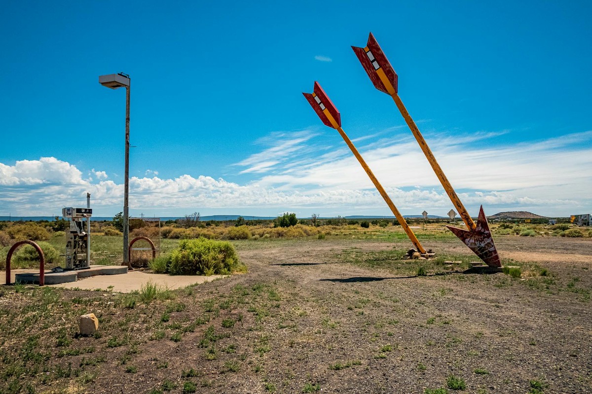 Two iconic giant arrows in the desert near Flagstaff, Arizona under a clear blue sky.