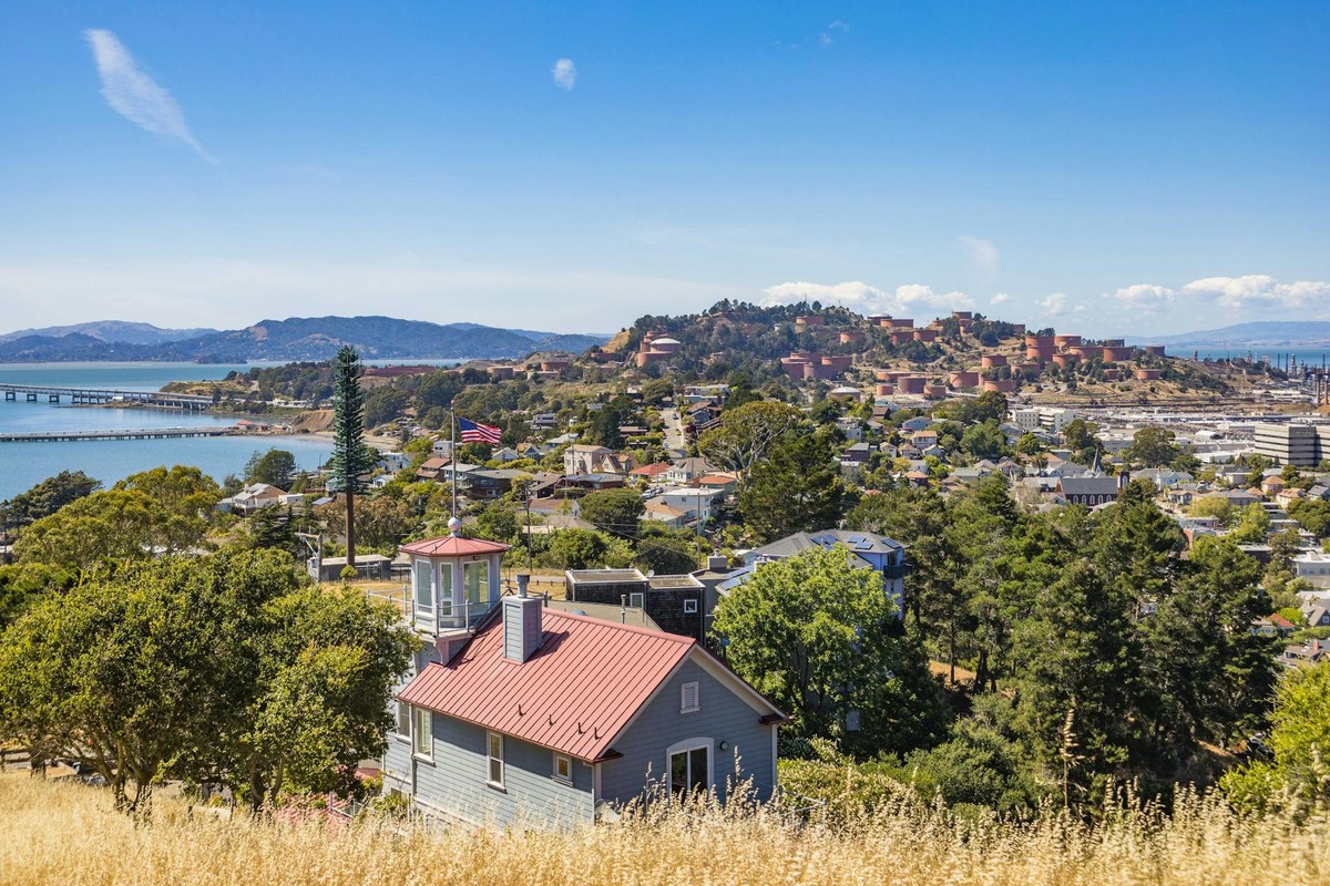 A picturesque view of Sausalito with an American flag and clear blue sky.