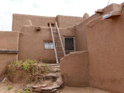 Traditional adobe architecture in Taos Pueblo, New Mexico showcasing rustic charm.