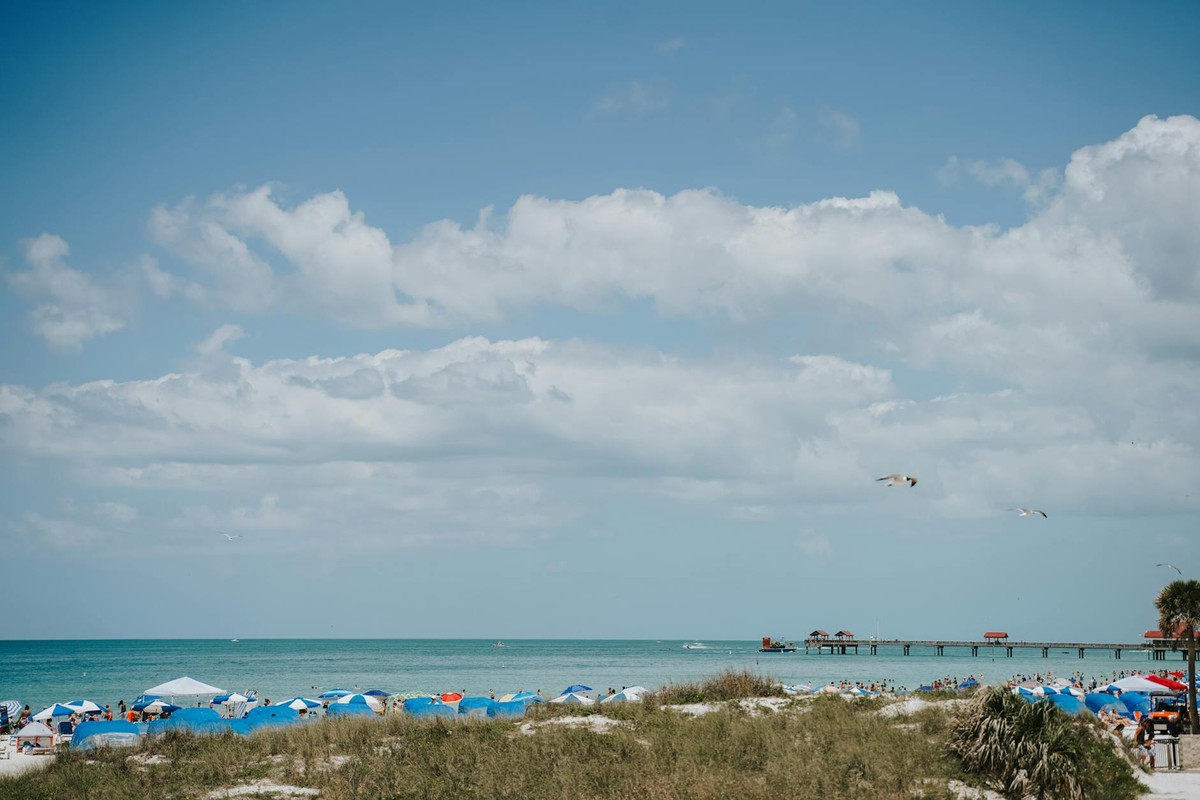 Relaxing scene of Clearwater Beach in Florida with beach umbrellas and a scenic ocean view.