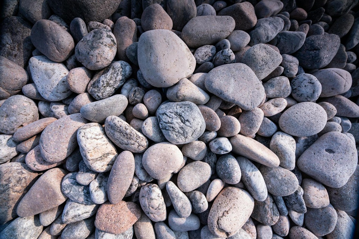 A detailed close-up of smooth, textured stones creating a natural background.