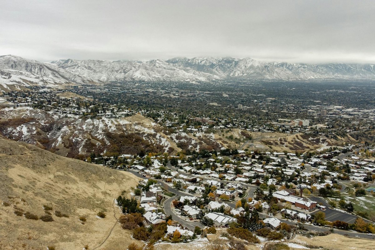 A stunning aerial perspective of snow-dusted Salt Lake City, highlighting its winter landscape and surrounding mountains.