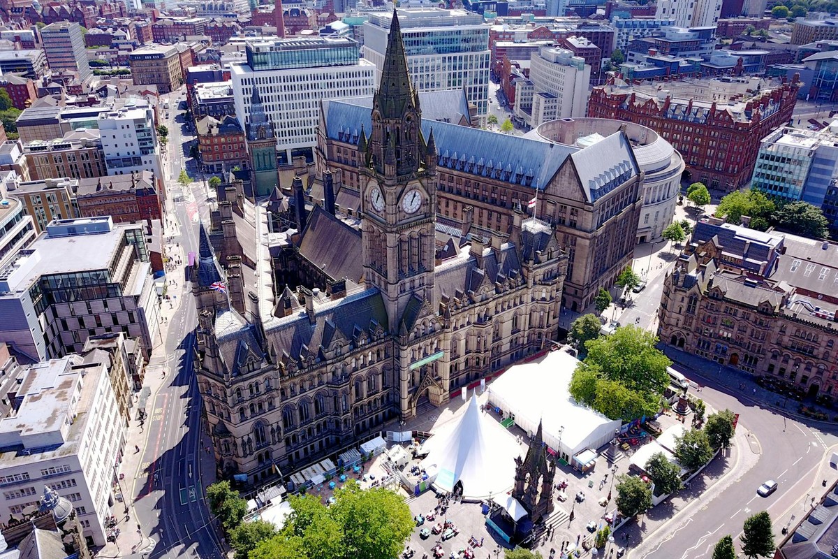 Aerial view of the iconic Manchester Town Hall and surrounding cityscape in the United Kingdom.