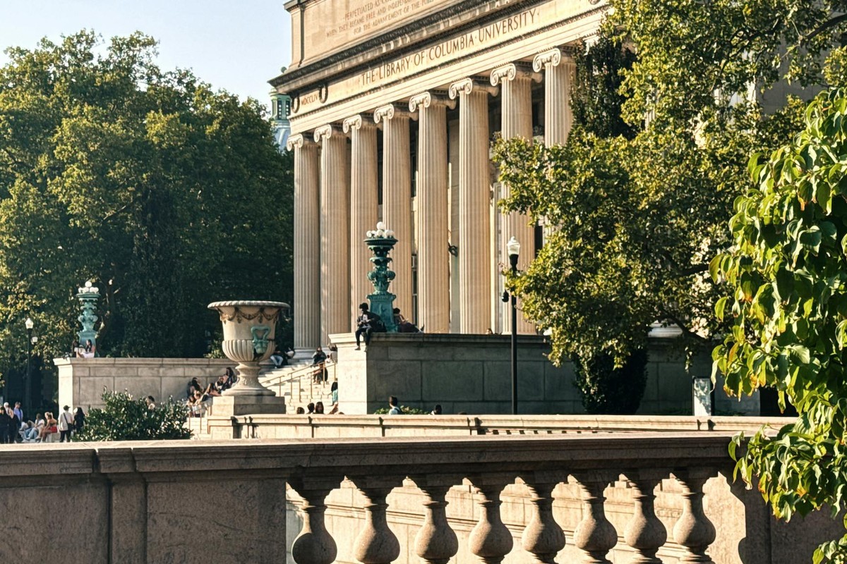 Sunny day at Columbia University Library, blending classic architecture with vibrant greenery.