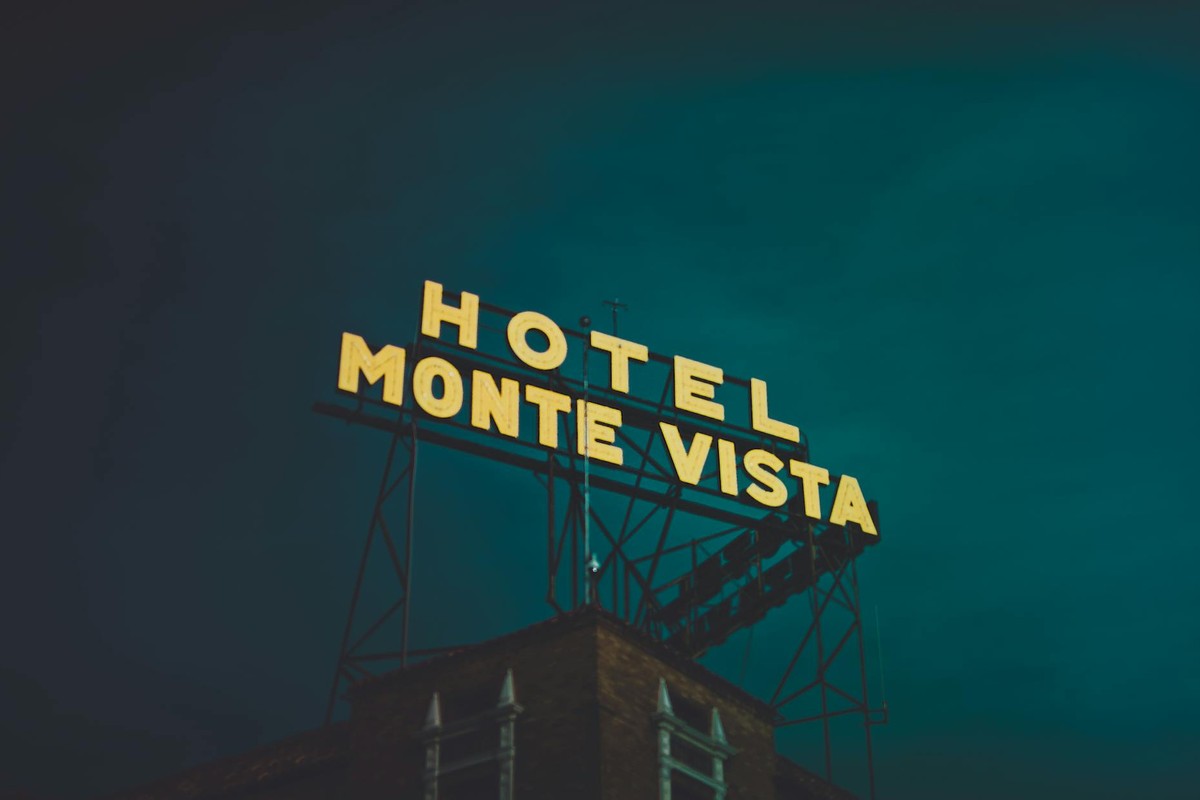 Illuminated Monte Vista hotel sign against a dark sky in Flagstaff, Arizona.