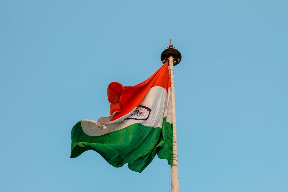 Indian national flag waving proudly against a clear blue sky in Jaipur, symbolizing patriotism and unity.
