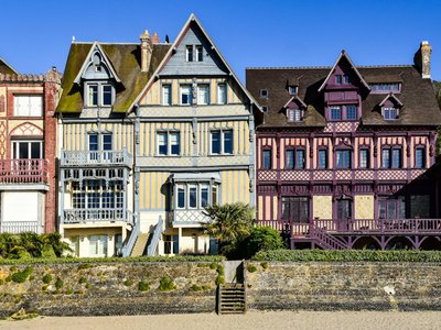 Colorful Norman-style villas in Deauville, France, showcasing elegant architecture by the beach.