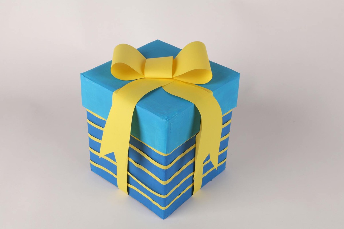 Colorful gift box with a bright yellow ribbon, perfect for celebrations.