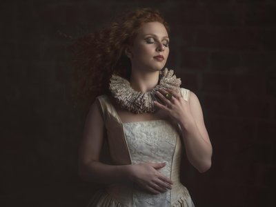A serene portrait of a woman in Renaissance attire with a detailed lace collar, elegant and classic.