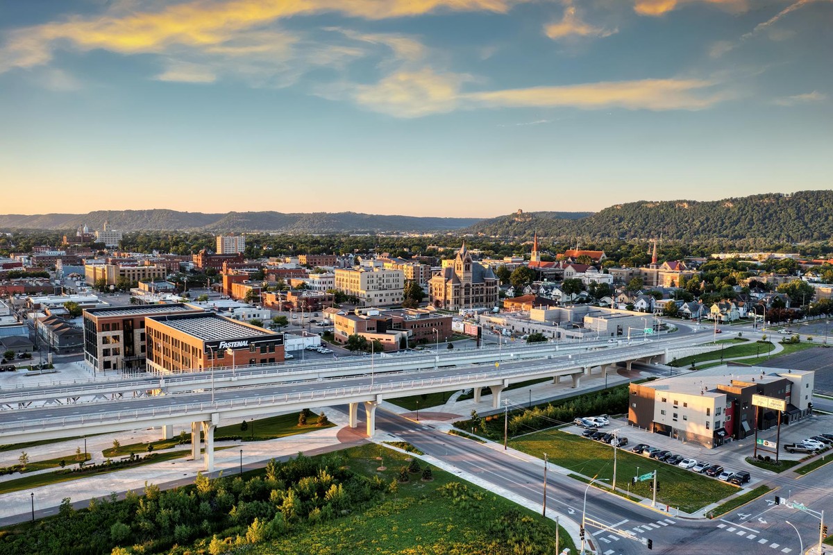 Aerial panorama of Winona, Minnesota showcasing the city's skyline at sunset.