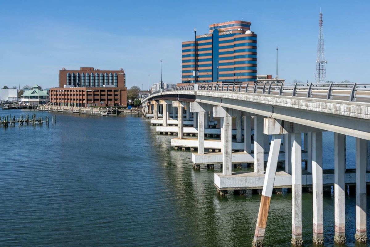 View of Hampton Harbor with prominent bridge and waterfront buildings on a clear day.