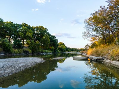 Serene scene of a tranquil lake and boat at sunset in Killeen, Texas, reflecting the beauty of nature.