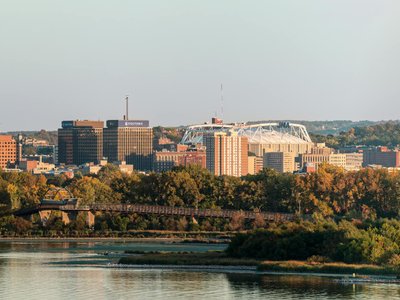 Panoramic view of Syracuse, New York skyline above Onondaga Lake during fall.