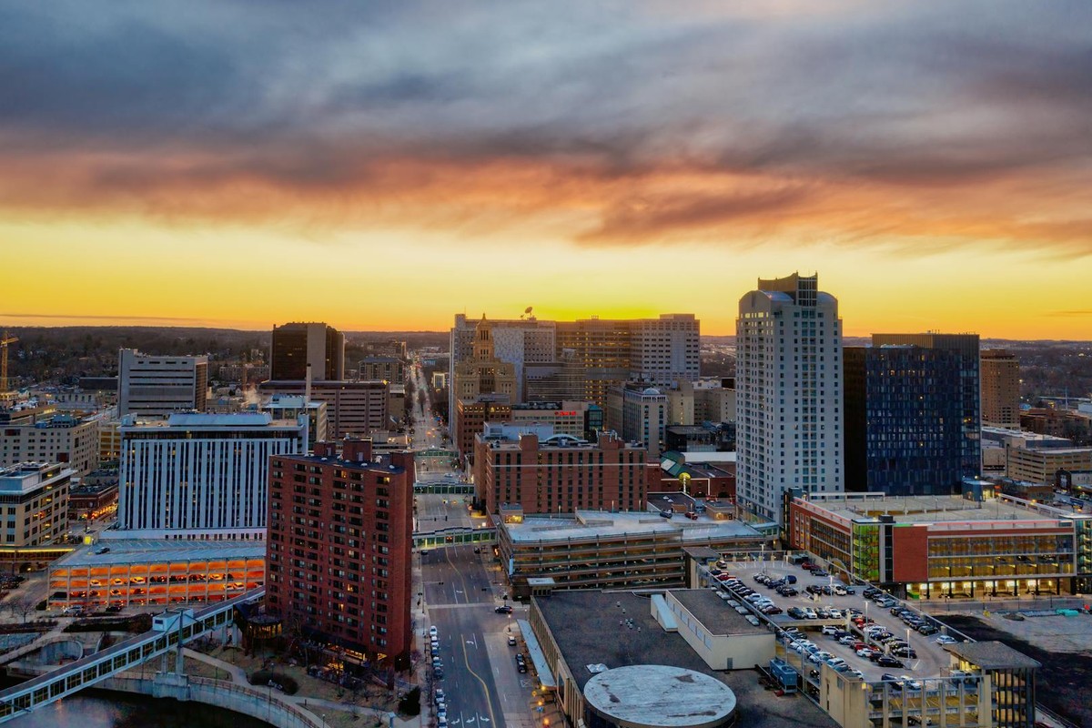 Stunning aerial image of Rochester, Minnesota skyline at sunset with dramatic skies.