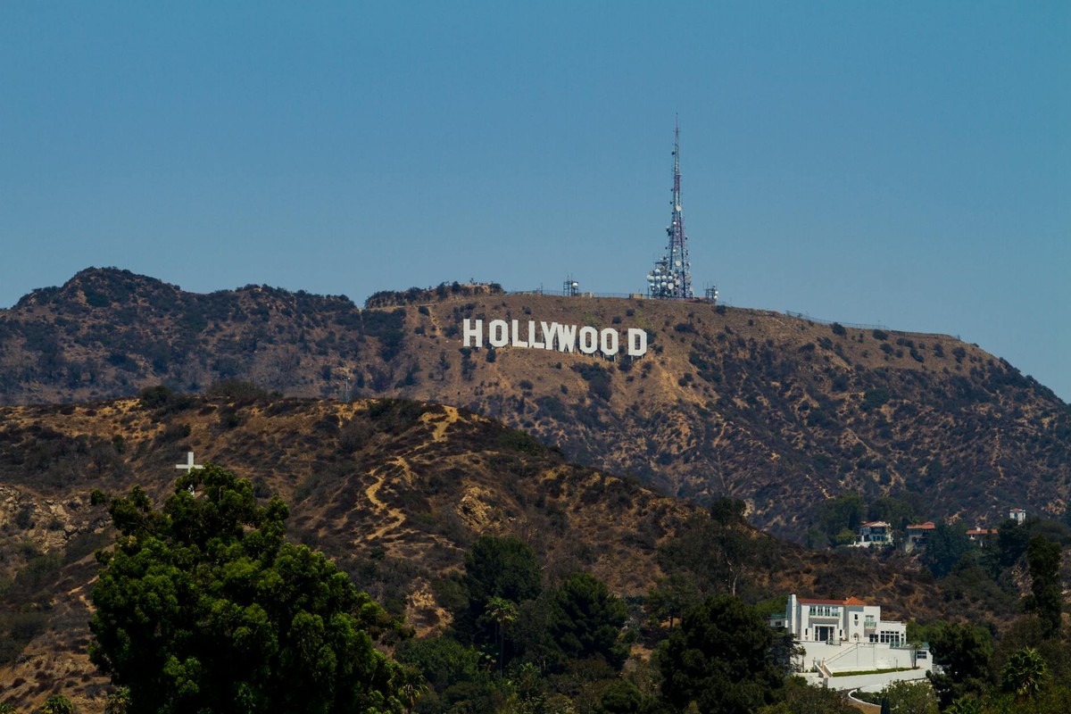 View of the iconic Hollywood Sign on Mount Lee with clear blue skies in Los Angeles, California.