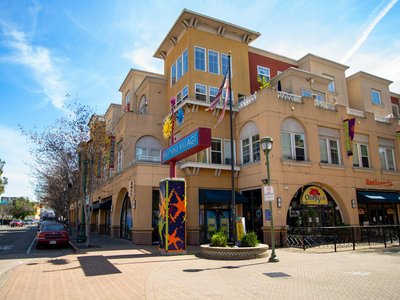 Colorful building exterior of Sunnyvale Village under a clear blue sky.