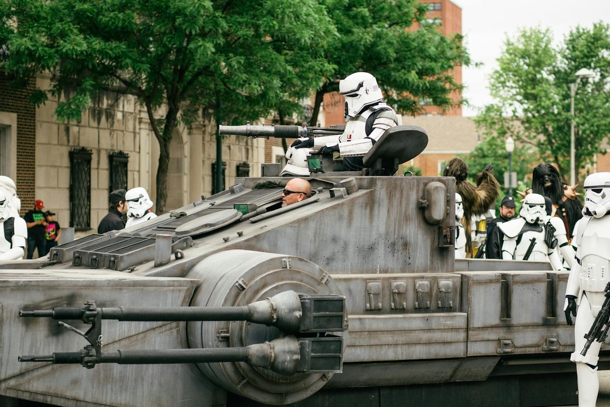 Stormtroopers participating in a cosplay parade featuring a tank-like vehicle in Joliet, IL.