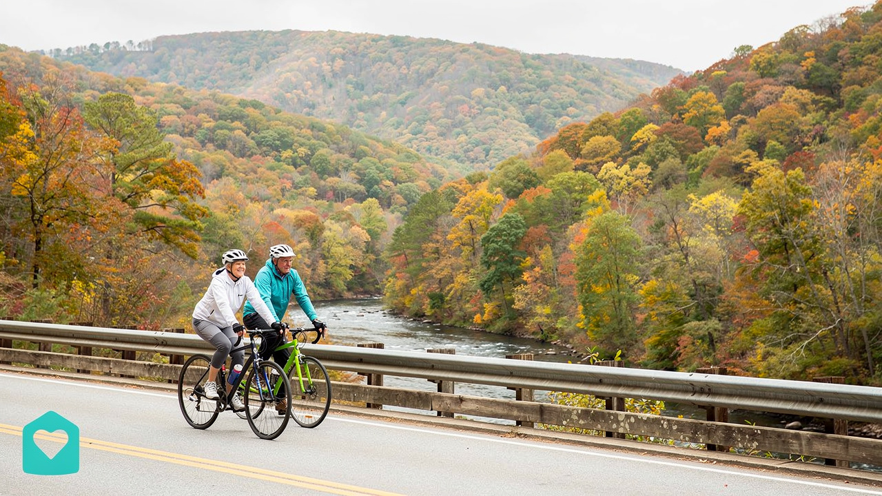 Retired couple cycling through colorful Southeast mountain landscape