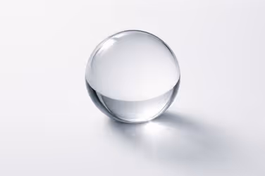 A clear glass sphere reflecting light, representing an independent operating lens and transparency.