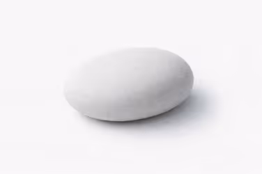 A smooth, oval-shaped polished stone on a white background, symbolizing balanced guidance and refined experience.