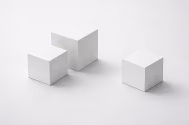 Three minimalist matte white cubes of different sizes on a light grey surface, representing emerging structures and new management entities.