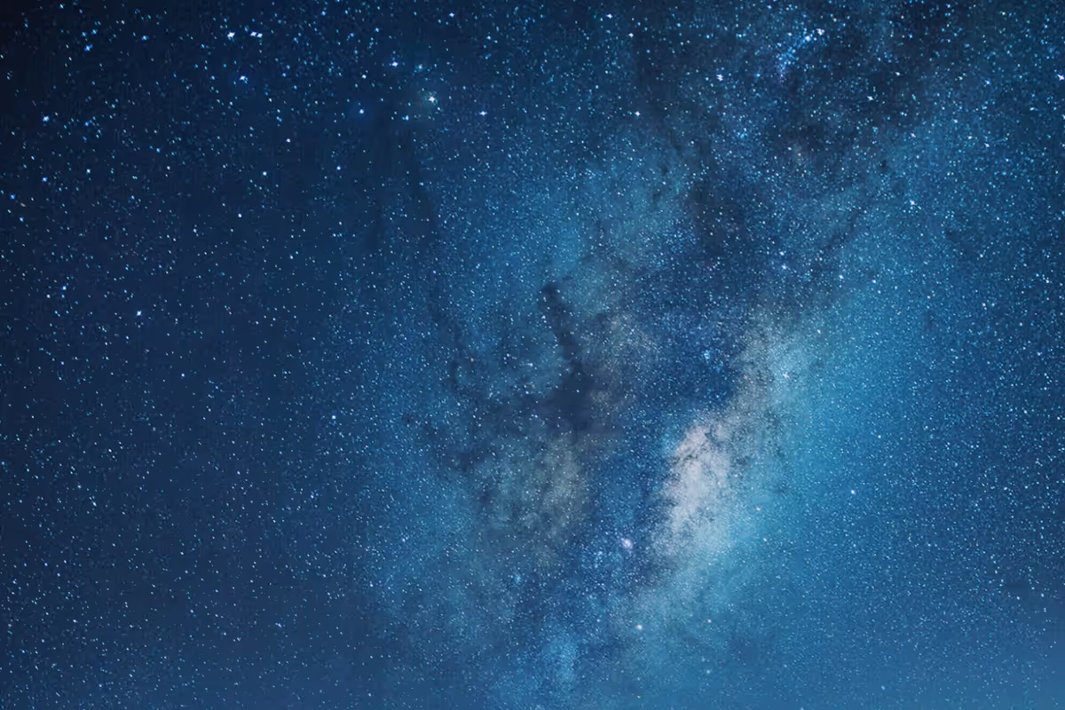 Dense star field and bright Milky Way galaxy core in a clear night sky.