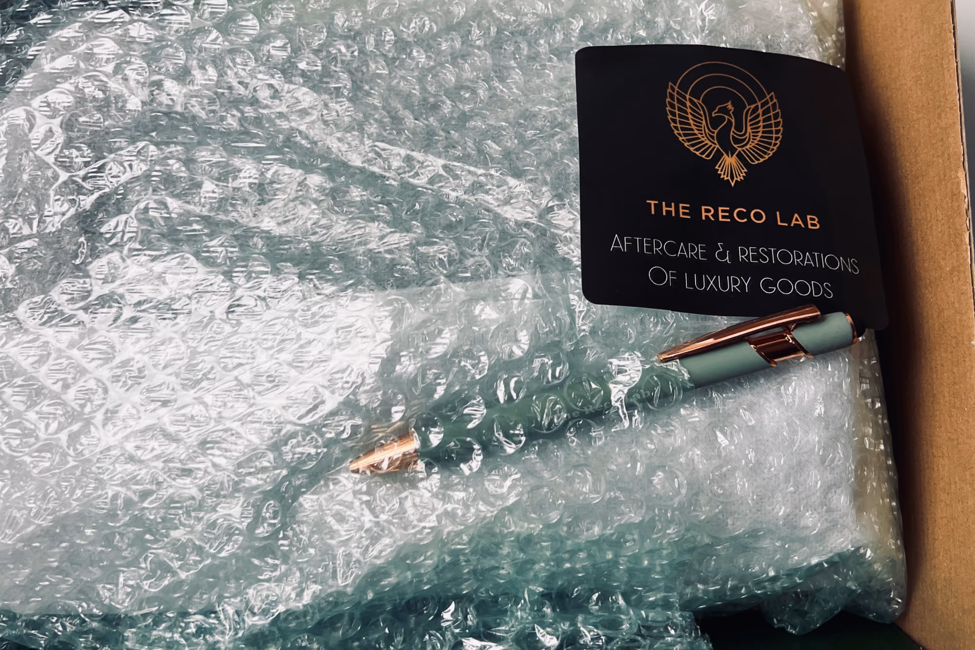 Item securely wrapped in bubble wrap with The Reco Lab packaging card for safe mail-in shipping
