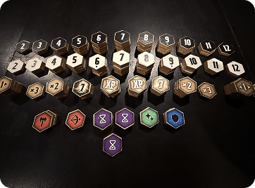 Collection of numbered, bonus, and colored essence hexagonal game tokens.