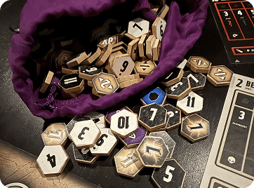 Numbered wooden game tokens spilling from a purple draw bag.
