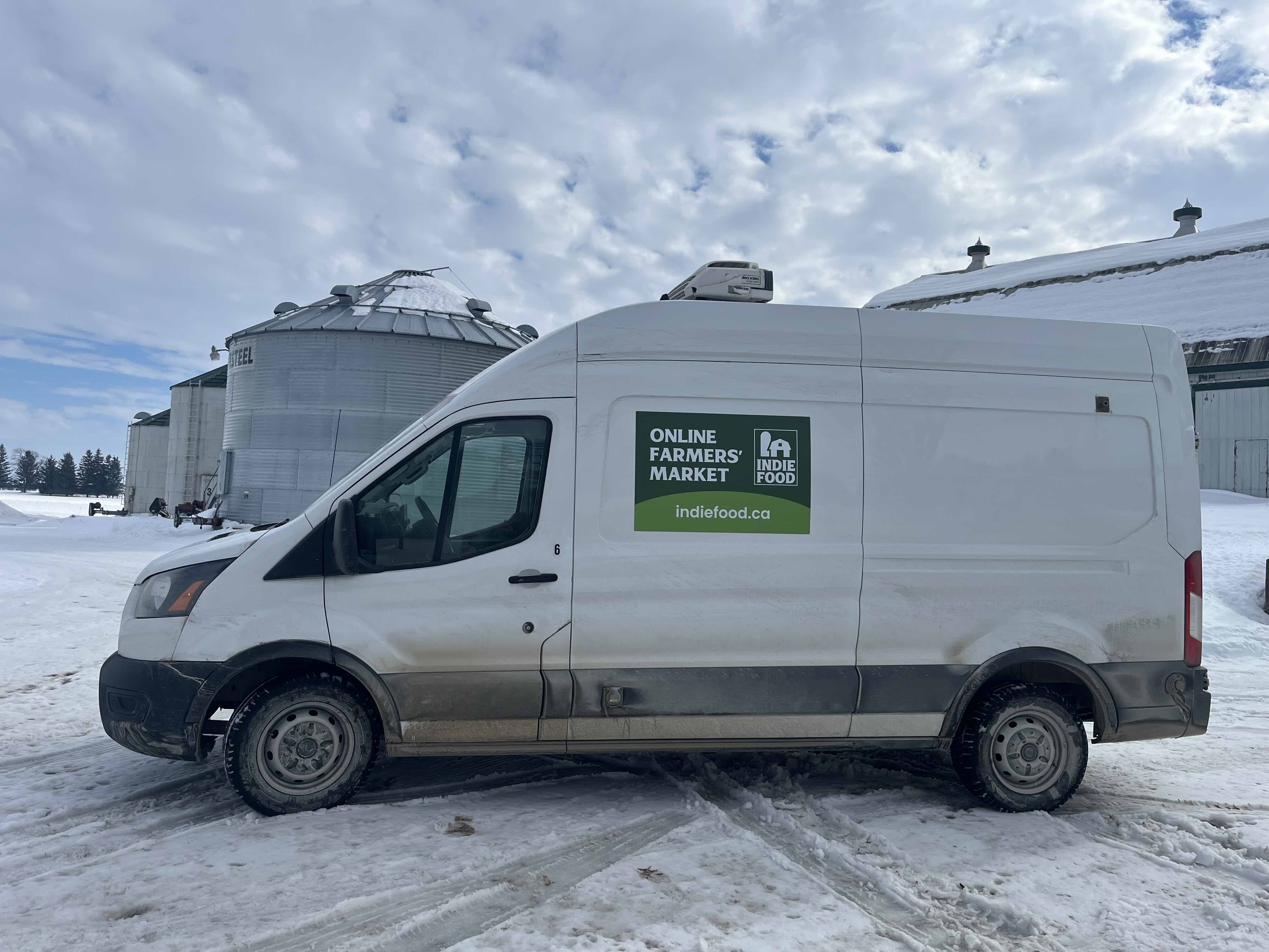 Indie Food delivery truck picking up from a local farm