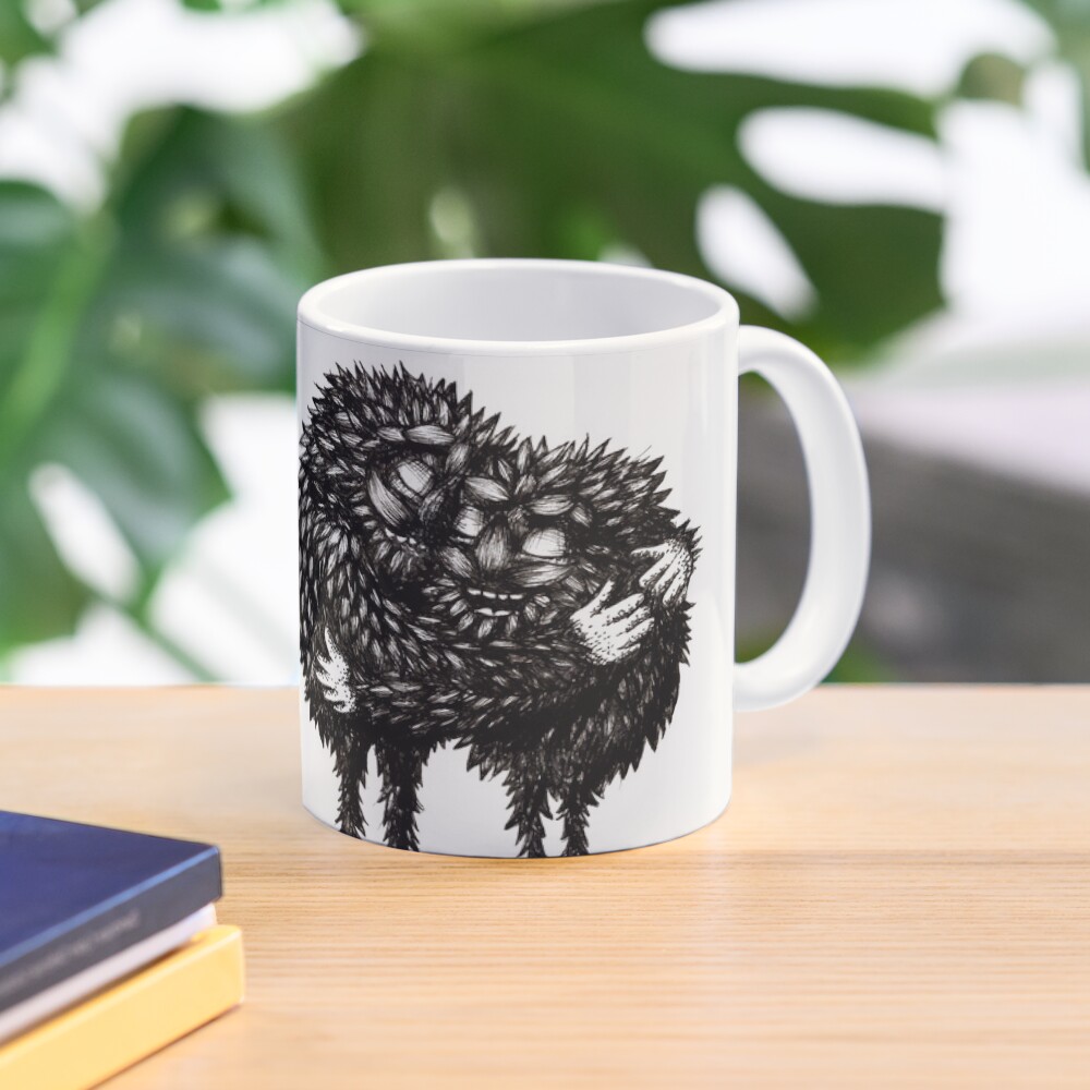 A mug of coffee with an illustration on it showing two black monsters by hugging.
