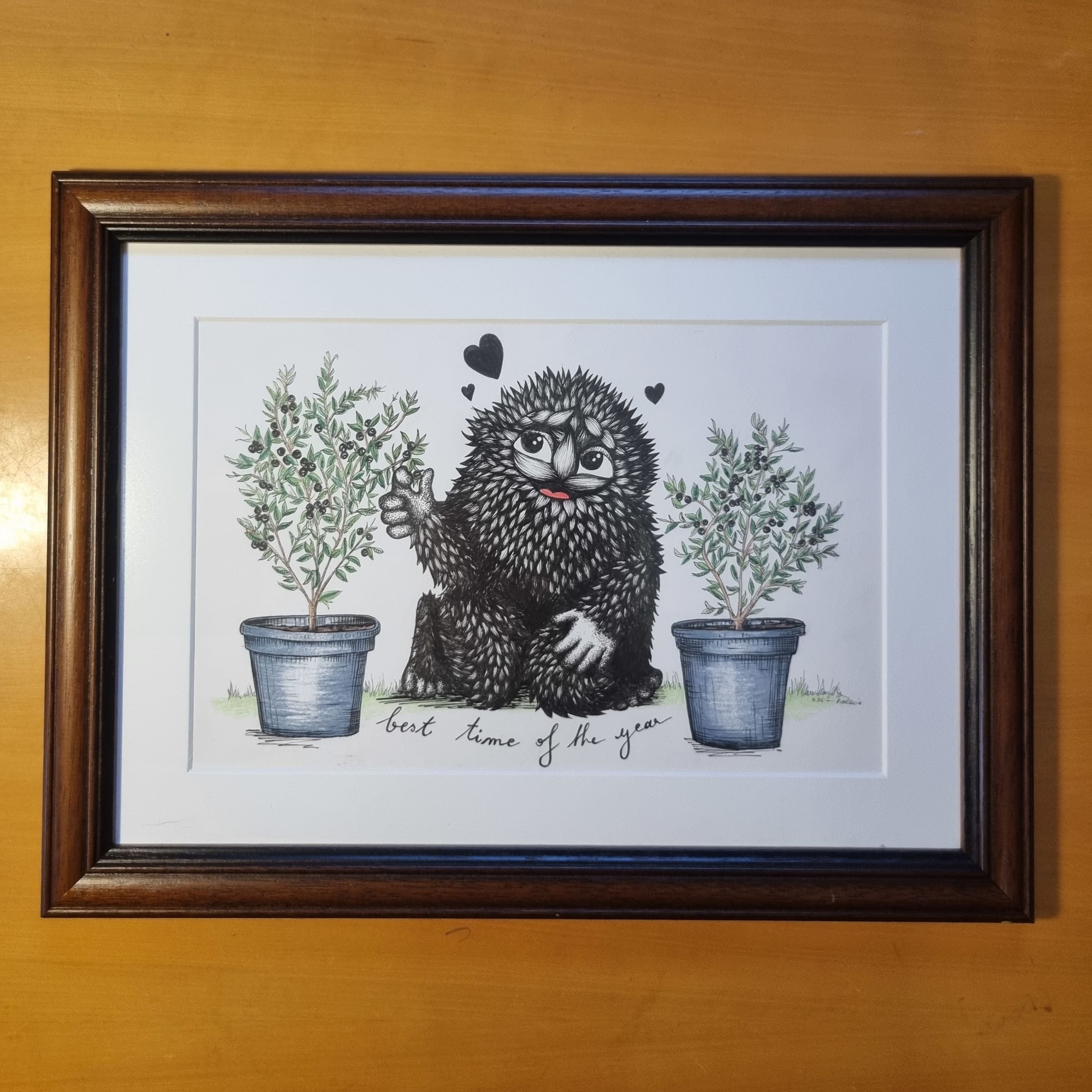 Cute furry black monster eating blueberry