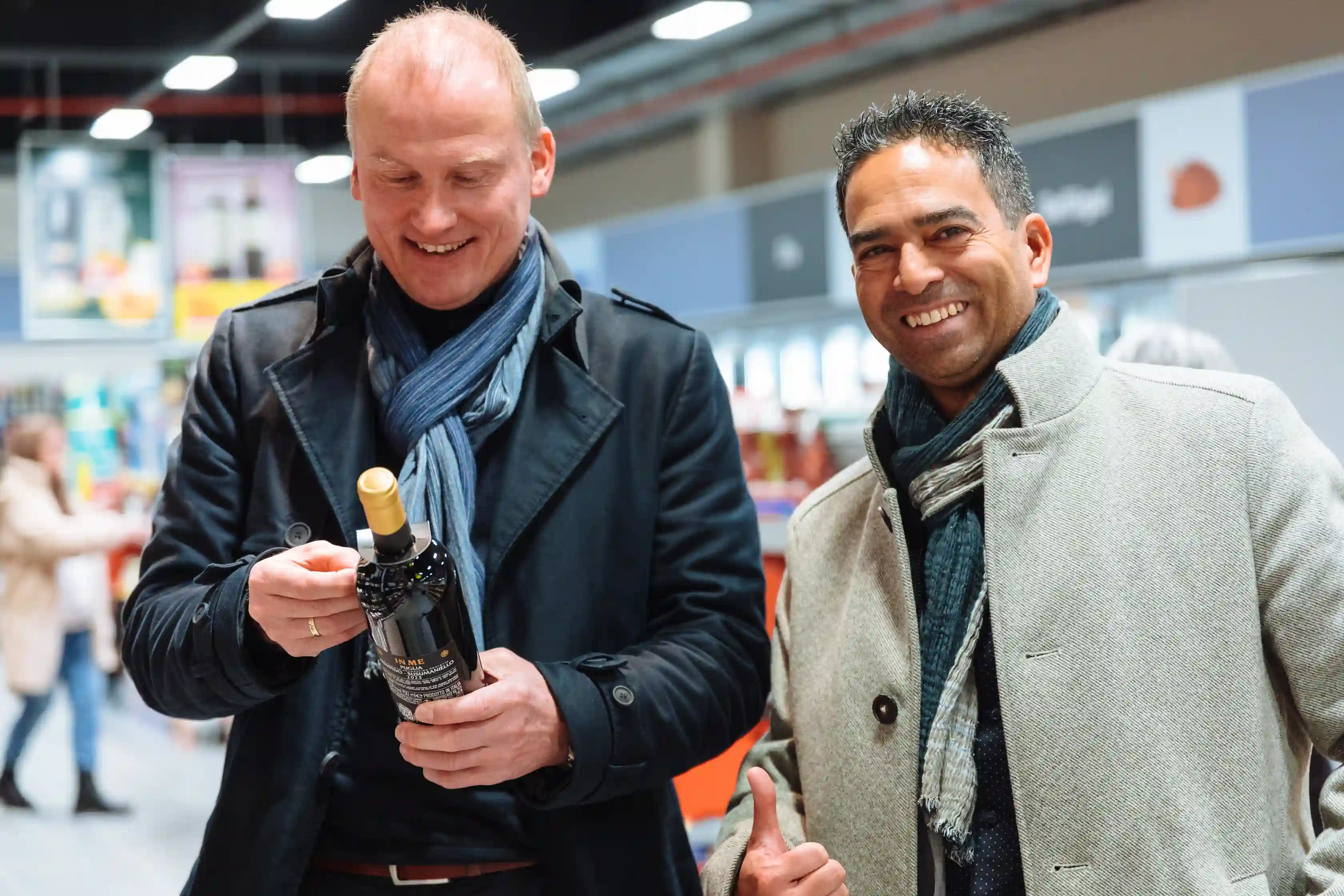 Zwei Geschäftspartner mit einer Flasche Sekt in der Hand um anzustoßen