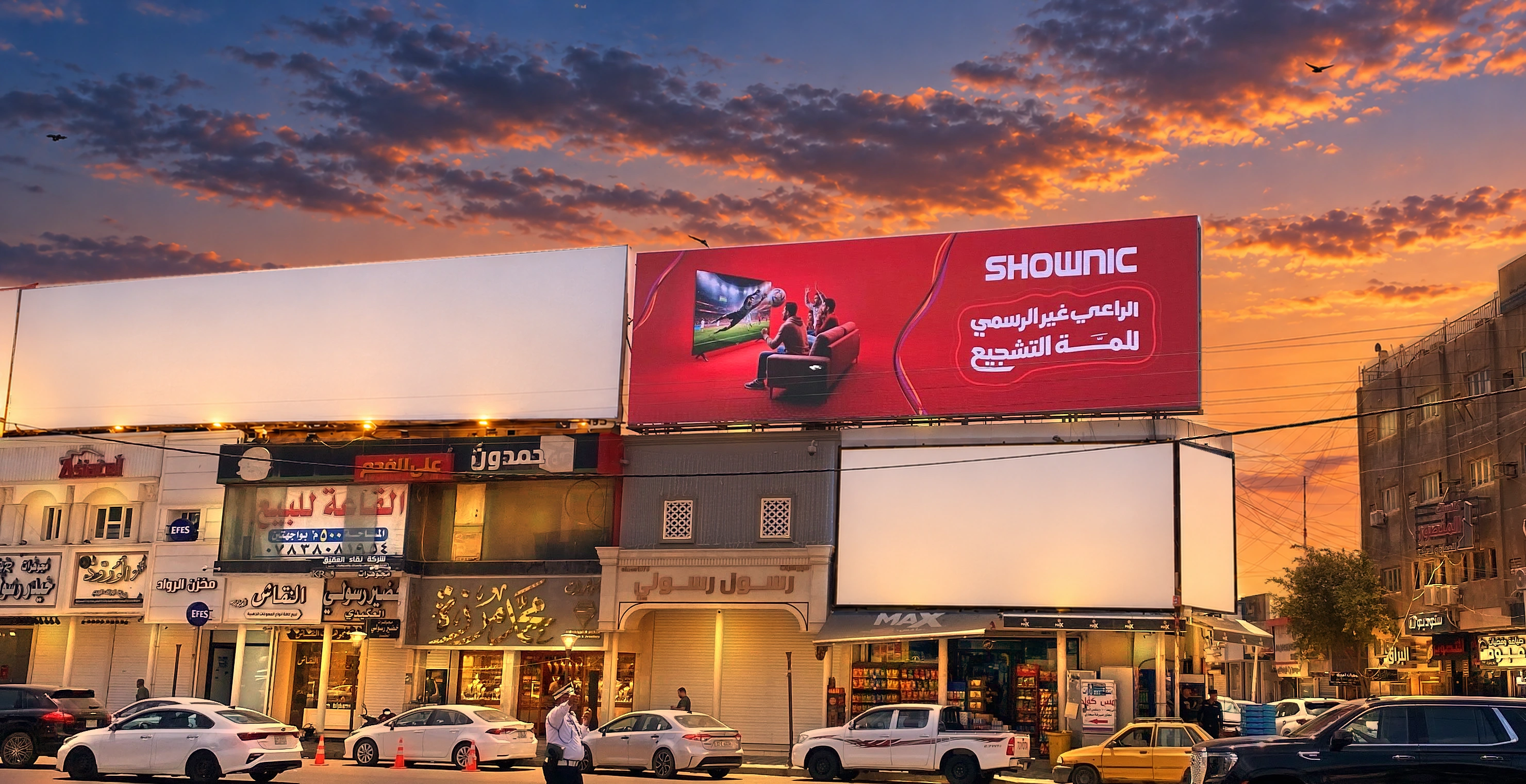 The Shownic billboard for Unofficial Sponsor of the Gathering, above a row of shops at sunset.