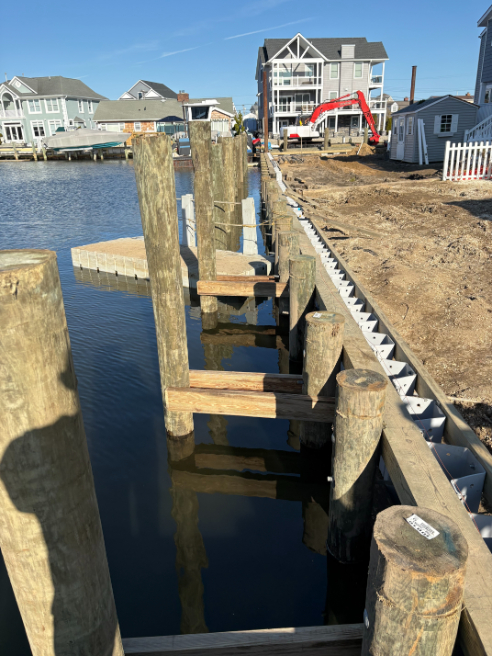 Residential canal bulkhead replacement and dock piling installation by Atlantic Industries Group marine division.