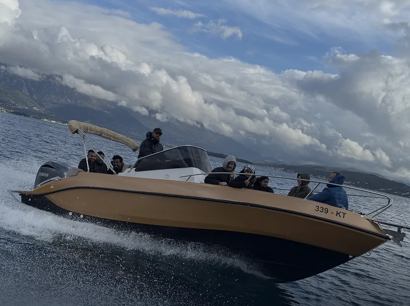 Group gold speedboat tour in Kotor Bay Montenegro with passengers enjoying the ride