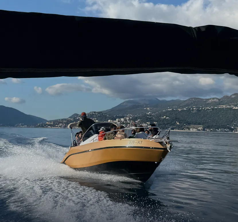 Speedboat ride in Kotor Bay with mountains in the background during a private tour