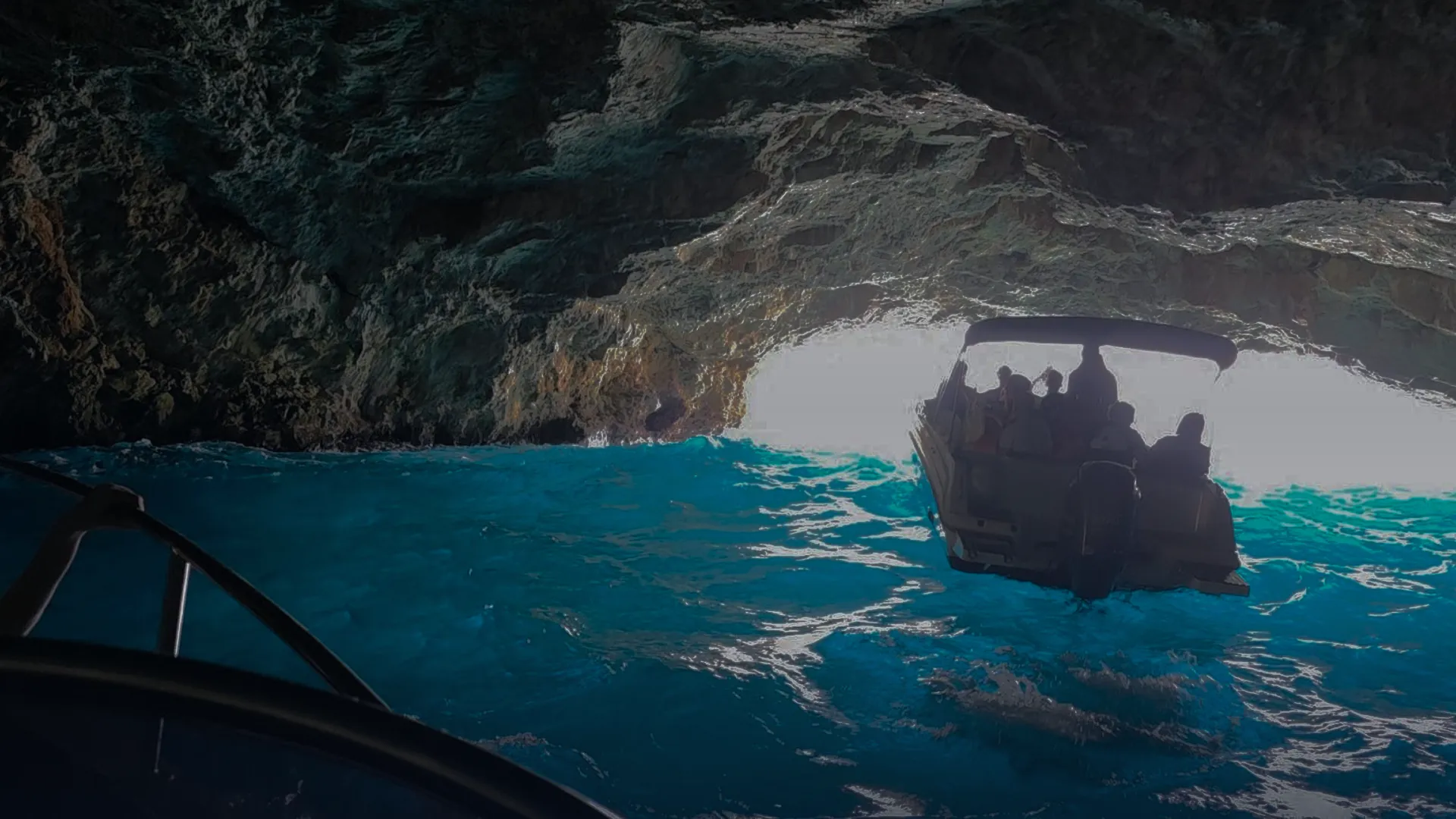 Private Blue Cave boat tour in Montenegro with tourists swimming inside the cave