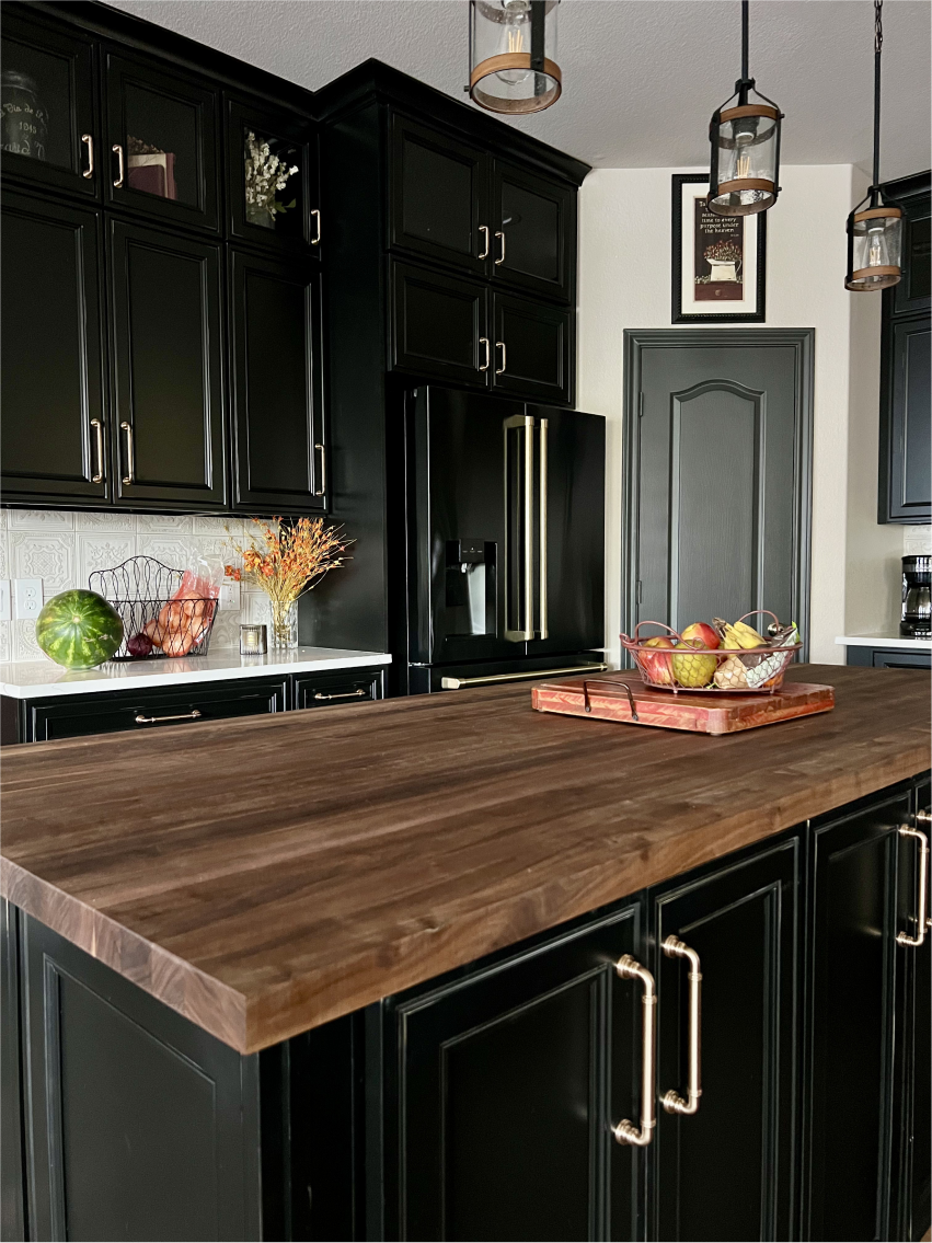 Remodeled kitchen with dark cabinets, patterned backsplash and wood island