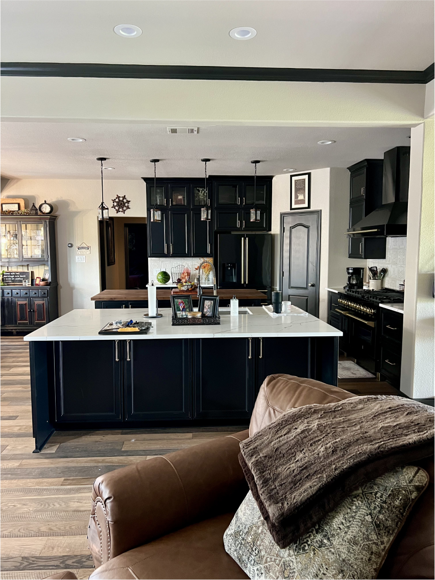 Completed kitchen remodel with a central island and pendant lights