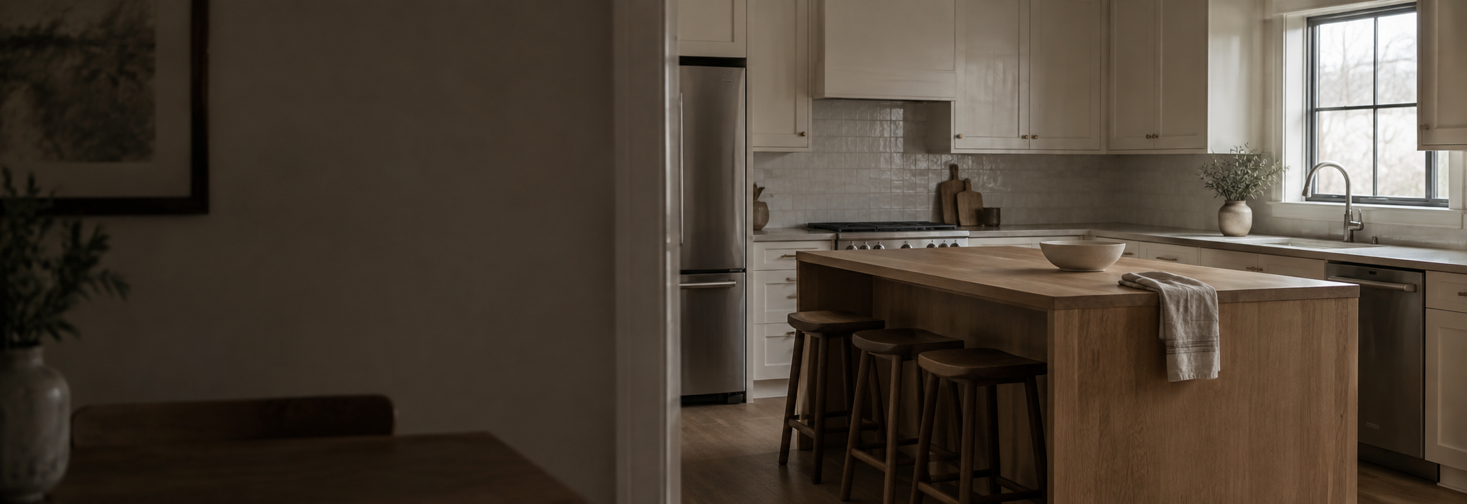 Kitchen with a wood island, light cabinetry, and natural window light