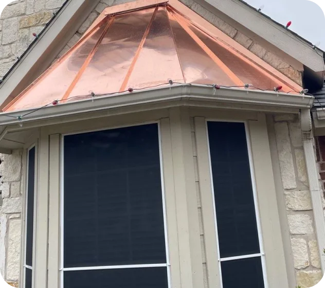 Bay window with black screens and beige trim under a polished copper roof with string lights.